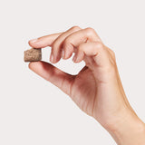 A hand holding one piece of Topper or Treat